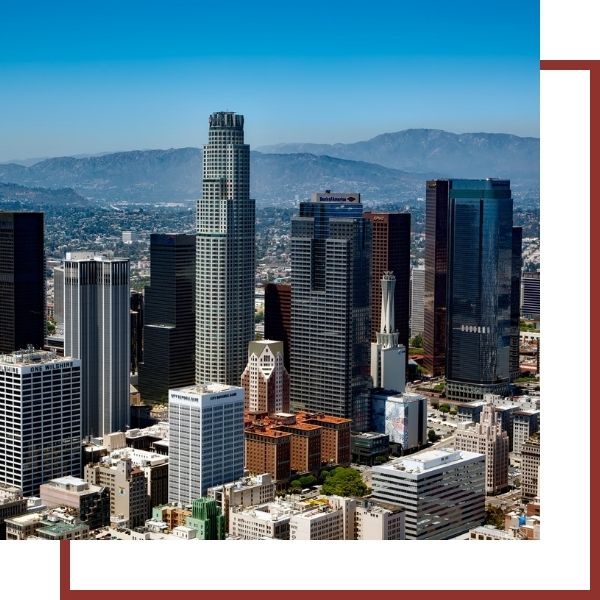 Skyline of modern skyscrapers with mountains in the distance